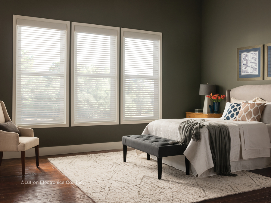 A luxury bedroom with light-filtering shades.