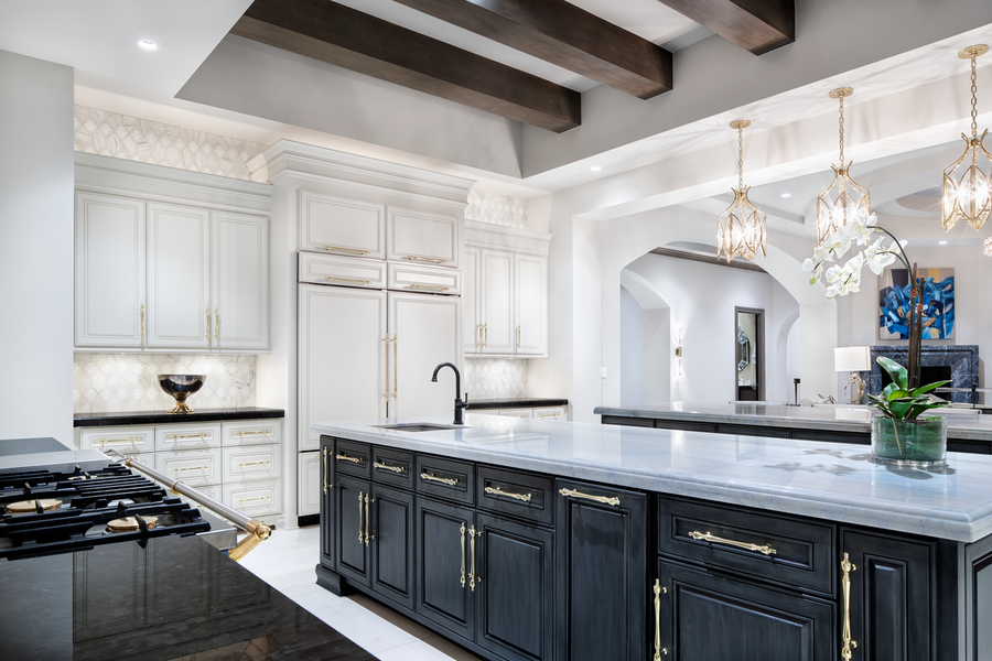 An illuminated kitchen featuring smart lighting fixtures to create a cohesive lighting design.